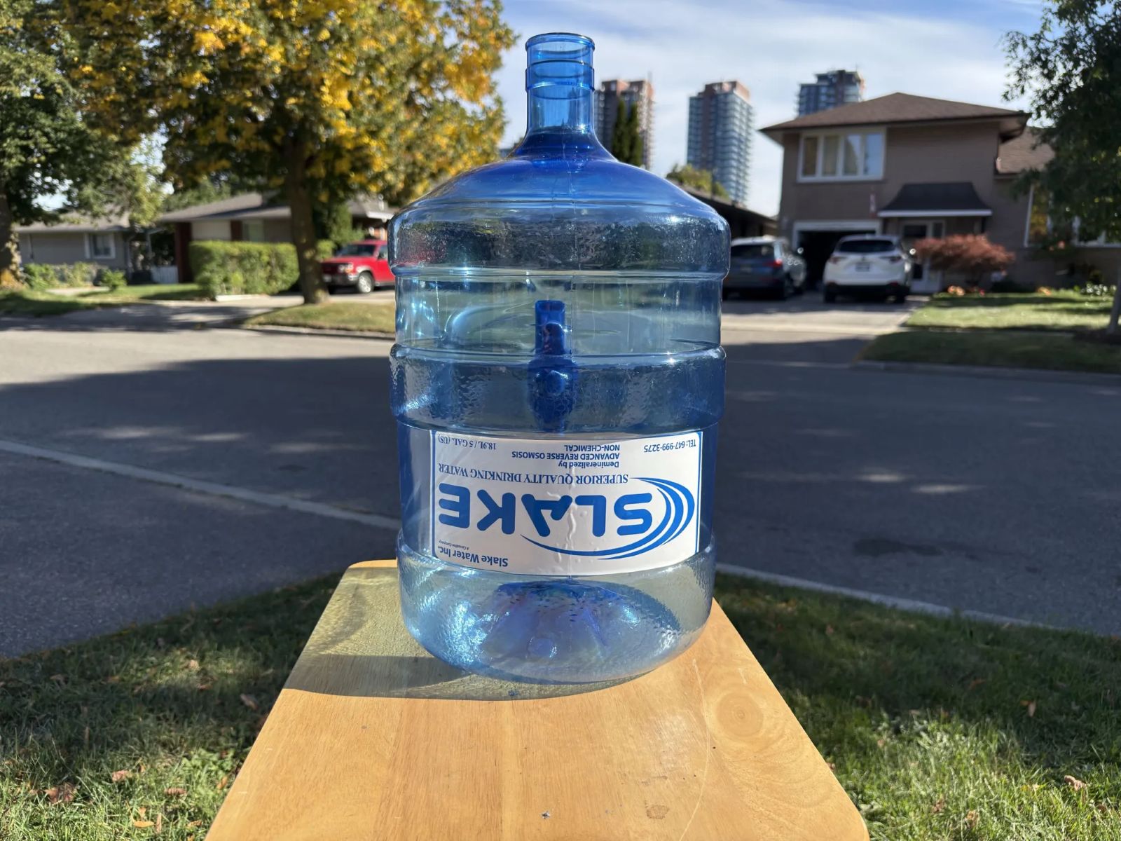 A Slake Water 5-gallon bottle on a table outdoors