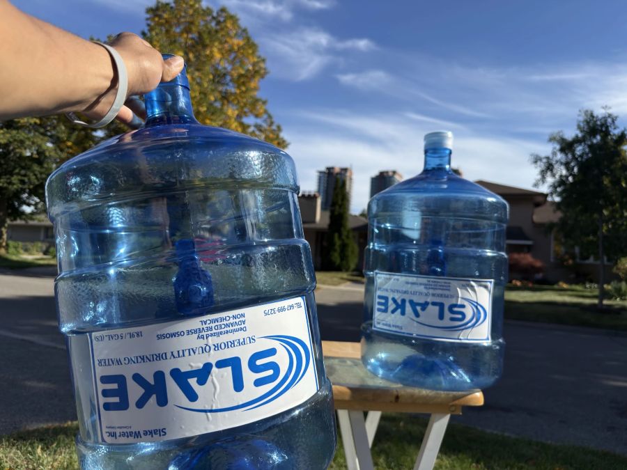 A Slake Water bottle carried by the neck